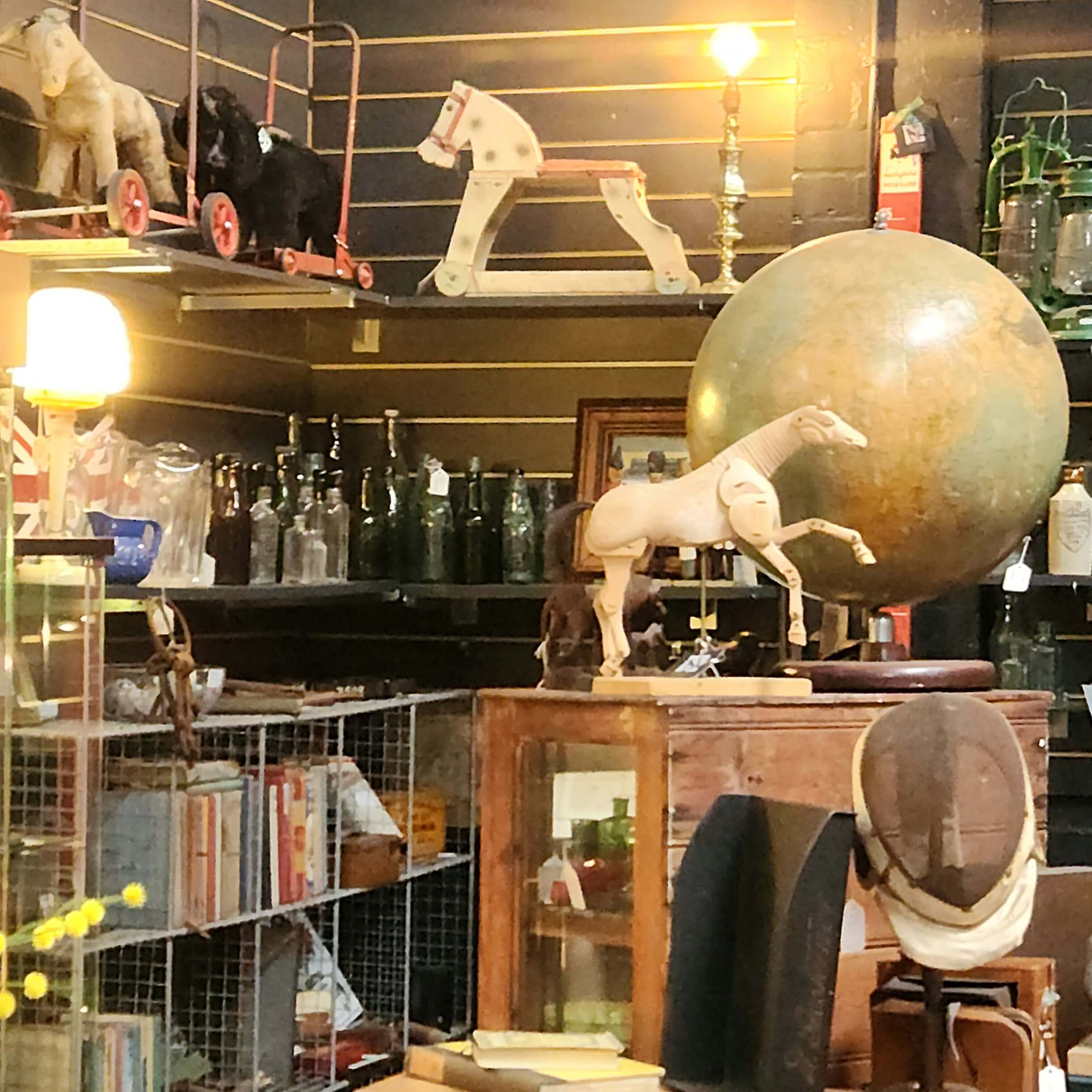 toy
                      horses on shelves. A globe.